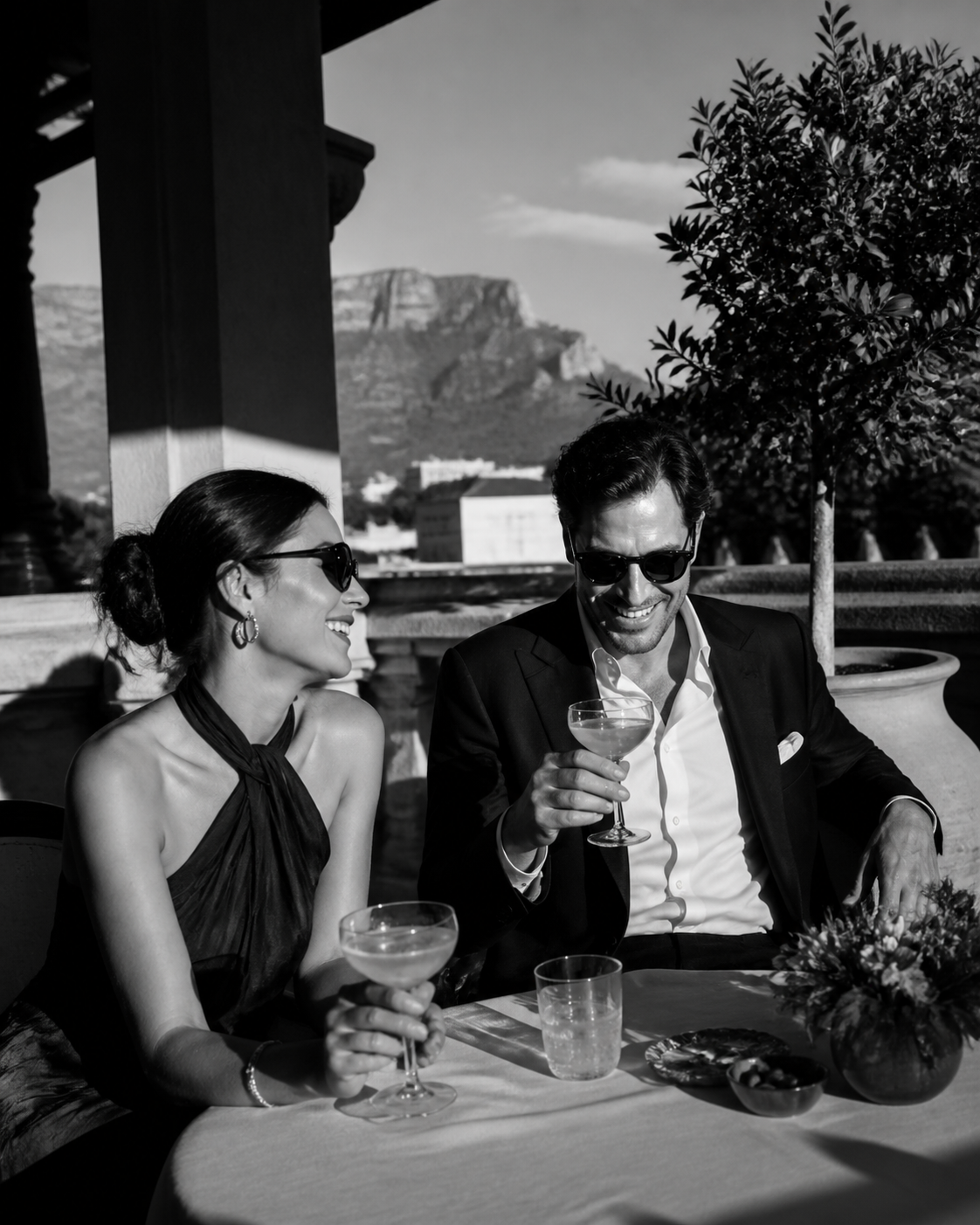 A stylish couple enjoying drinks on a Cape Town terrace